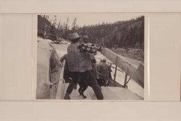 Carl Kriley and Don Smith at the hard work of the sweeps of the Salmon River scow