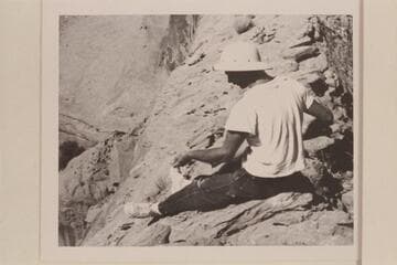 Norm Nevills measuring the "Gregory Bridge" in the side canyon of Escalante Canyon