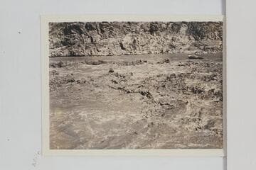 Pipe Creek Rapid.  Boat of the Dusty Dozen crew back of wave left of center with just the boatman's head showing