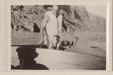 Harry Aleson at the controls of the "Up Colorado" running downstream a few miles above Bridge Canyon to the drill camp at Bridge Canyon.  Afternoon light