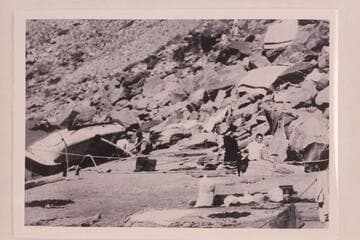 The "Powell," one of Eddy's big boats rolled on shore for repairs after capsizing during lining in Cataract Canyon at the head of the Big Drop