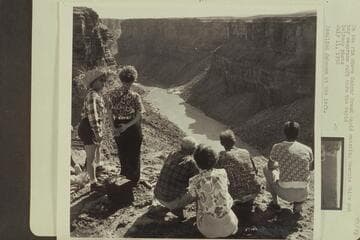 On the rim above Badger Creek Rapid watching Georgie White put her neoprene raft through the rapid.  Rosalind Johnson at the left