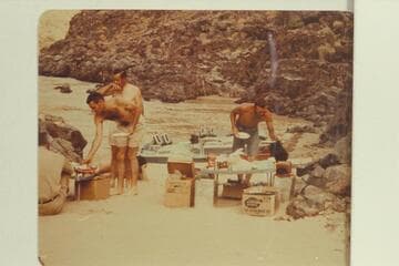 Breakfast at camp at Switching Yard.  John Schulz sits at edge of picture.  Garth Marston leans down for some food.  Chuck Richey.  Larry Sanderson pours coffee