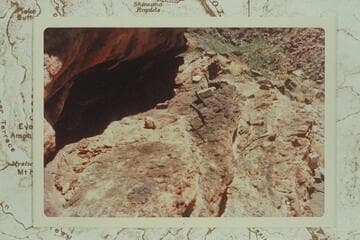 The upper story of the "Houserock" at the Bass Mine in Hakatai Canyon.  Note the poles inserted into holes in the ledge.  This ledge is about half way up the rock