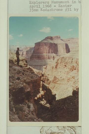 On left cliff of Royal Arch Canyon.  Explorers Monument in background