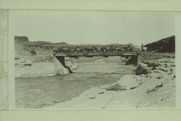 Spencer pack outfit crossing the bridge below Mexican Hat