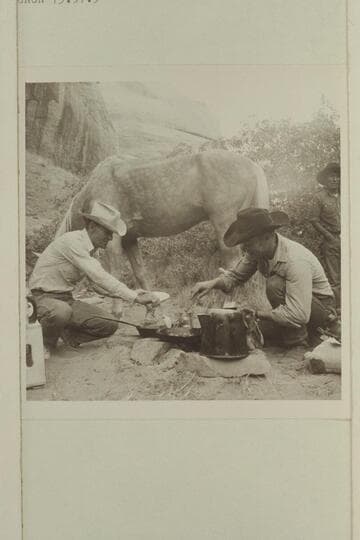 Tom Daly and Buster Ordiway create pancakes in camp of middle fork.  Tobe Owl at right