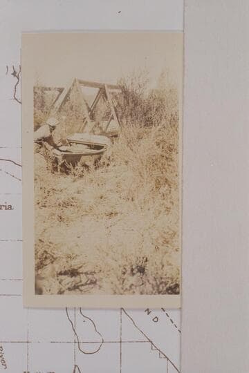 Portage of Freeman's boat around a low bridge on the Alamo River