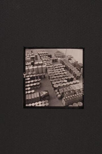 Bill Belknap checks the supplies at Boulder City before taking them to Lees Ferry and other points. Outboard motor traverse of the Grand Canyon