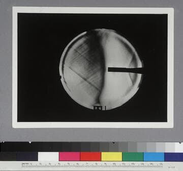Shadow photograph of wind tunnel test results, showing air stream from a cylindrical model