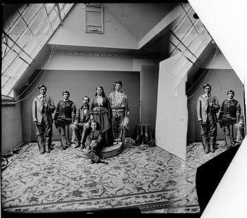 Modoc Indians and others in photographer's studio. Left to right: George Harney (Takelma Indian); Scarface Charley, Frank Riddle (seated), Tobey Riddle and son Jeff Riddle, Dave Hill (Warm Springs scout)