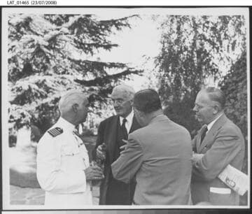 Harry Chandler speaks outside with 3 gentlemen