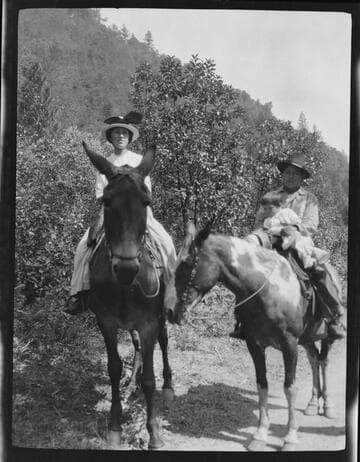 Native American woman, baby and man on horses