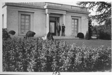Henry E. Huntington and his personal secretary, Mr. Varnum, in front of  the billiard, pool, and bowling building on the Huntington grounds, circa 1915