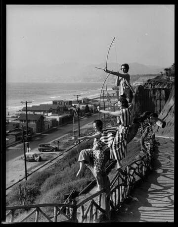 Models posing as archers on the road to Palisades Park, Santa Monica
