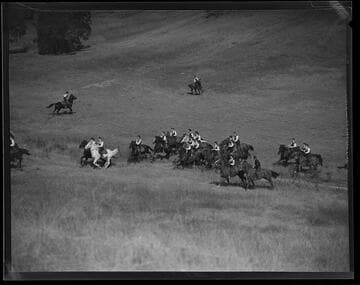 Santa Monica Lancerettes riding horses through a field