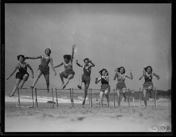 Roger Cornell's Athletic Club women jumping hurdles on the beach, Santa Monica