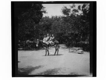 Children on burro at Piru Mansion