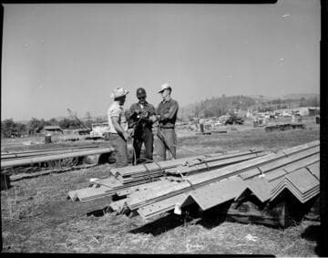 Airlifting tower steel from staging area to tower site using large Sikorsky helicopter