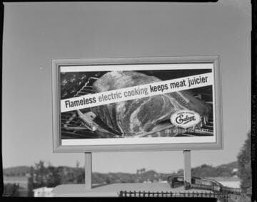 Small models of Edison "Flameless Electric Cooking Keeps Meat Juicier - Live Better Electrically" billboards