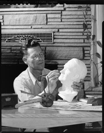 Man sculpting a bust of a man's head with 3 variants