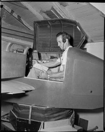 Man is sitting in what looks like a flight simulator
