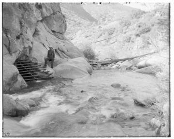 A man standing at the entrance of a tunnel intake of Kaweah #1 Hydro Plant