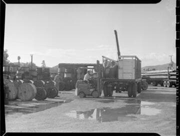 Loading materials onto flat bed truck with fork lift