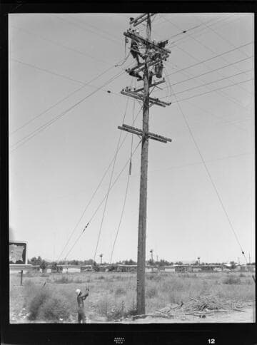 Linemen working at top of transformer pole