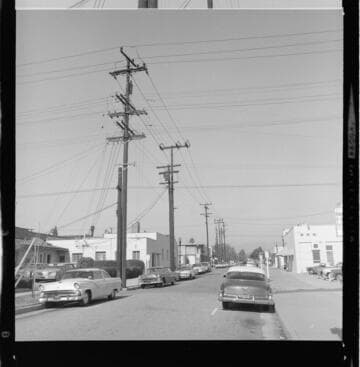 Linemen stringing conductors on transmission poles