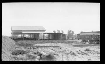 Buildings with two unhitched Imperial Ice wagons outside