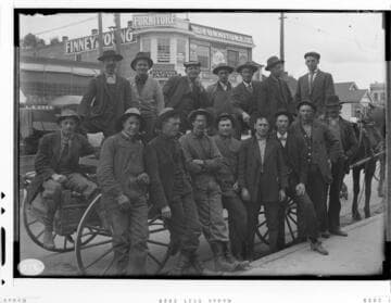 A group portrait of the Long Beach E.D.S. (Electric Distribution System) Gang leaning against a wagon