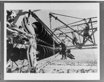Edison Company linemen use a "shepherd's hook" tool to install a 500kV insulator on a Pacific Intertie tower