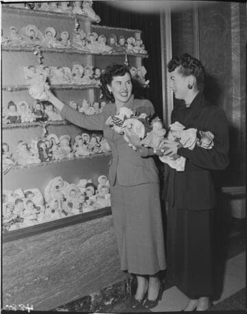 Two ladies with Christmas doll display