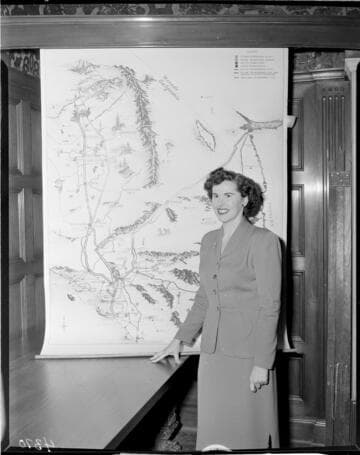 Woman standing in front of display map of Edison system at the GO