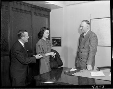 Man introducing young lady (new employee) to executive
