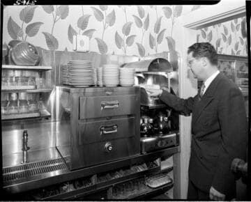 man starting coffee maker in cafeteria