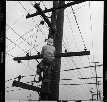 Linemen on working poles