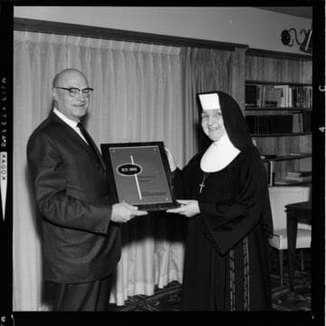 Achievement award for superlative food service presented to Nun from Maycrest Manor