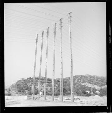 Six tall, small footprint, high-voltage, double-circuit towers (side-by-side)
