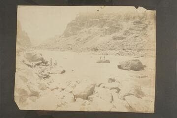 McDonald and Kane on the rock attempting the salvage of the wrecked Boat No. 1.  The point is Mile 204 1/2