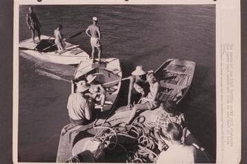 The boats of the 1948 Nevills party pull alongside the power boat which met them at the head of Lake Mead