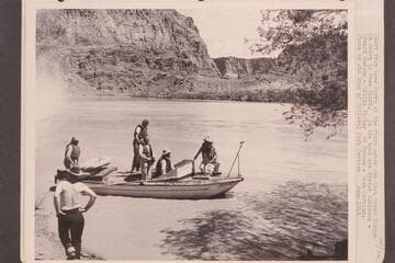 Start from Lees Ferry of the first motor run through Grand Canyon.  On shore is Owen Clark and in the boat are:  Bestor Robinson, Edward Hudson, Willie Taylor, Ed Hudson and Dock Marston