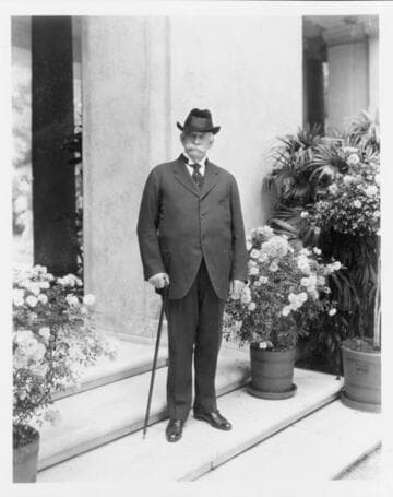 Portrait of Henry E. Huntington on loggia steps, circa 1920