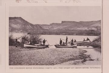 The 3 boats and their crews of second cruise by Powell down Green and Colorado Rivers as they appeared from left bank of the Green at Green River, Wyoming.Boats and costumes are ill-suited to River work and illustrate lack of adequate preparation