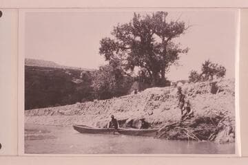 Four miles southwest of Bluff, Utah, where boats were launched 1921, July 18.  Low cliff on top part of Navajo sandstone next to river.  Picture taken just after launching boats