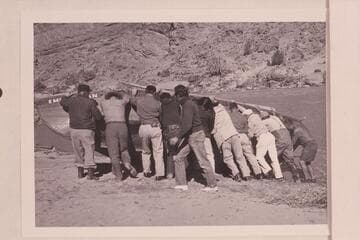 The "Emma Dean" being rolled for attaching cable.Above Moab.Tom Coleman is at left;then Jim Drury;Rusty, of props; two of the grips;Russ Haverick with the light coat at center.The man in white is Frank Baker, the painter.Jim and Roy Bolton