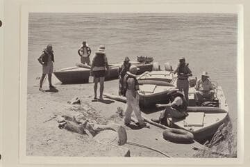 Just before departure for Grand Canyon traverse of 1954, June.Masland stands at left.Eisaman stands in the "Bootoo."Visbak carried the steel box.Taylor is almost hidden by Marston.Sanderson sits on bow of "Rattlesnake."