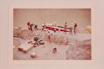 The holed "Big Red" at Mile 3 1/2 after unloading and as preparations are made for lifting her for patching