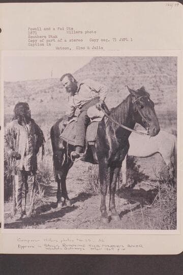 Powell and a Pai Ute.  Southern Utah.  Copy of part of a stereo with caption:  "Watson, Elmo & Julia."  Major Powell inquires way to a water hole near the Grand Canyon